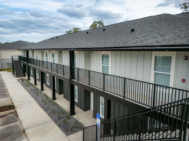Brand-new apartment building with black-railed balconies at Huntington Forest