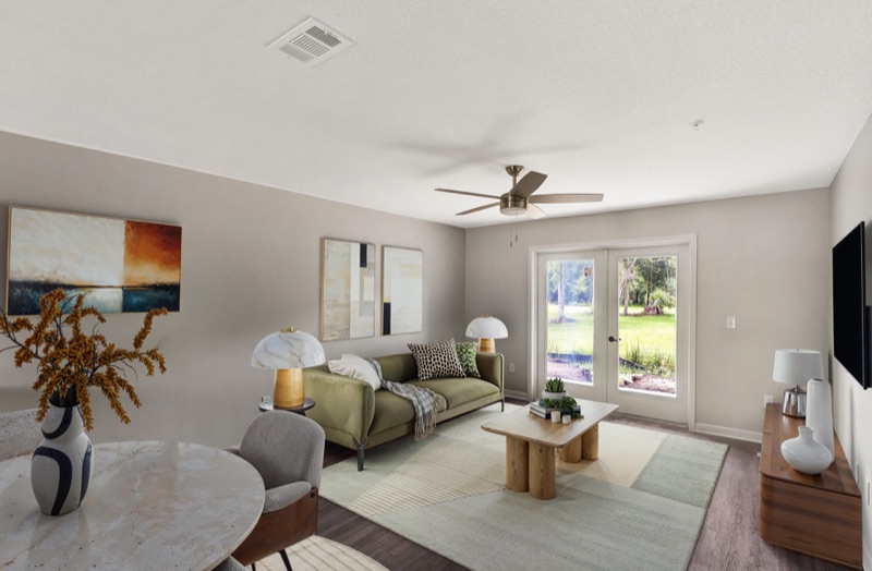 Living room with patio doors to a green lawn at Huntington Forest
